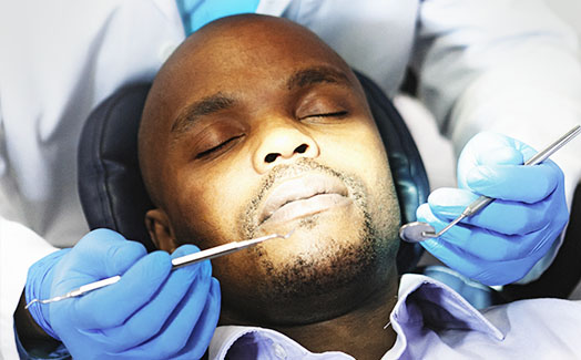 Man asleep during dental procedure